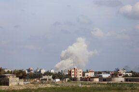 Smoke rises following an Israeli strike in the central Gaza Strip