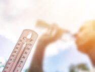 Man,Drinking,Water,In,Extreme,Heat,,Thermometer,In,Summer,Day