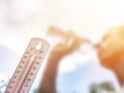 Man,Drinking,Water,In,Extreme,Heat,,Thermometer,In,Summer,Day