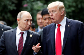 FILE PHOTO: U.S. President Donald Trump and Russia’s President Vladimir Putin talk during the family photo session at the APEC Summit in Danang