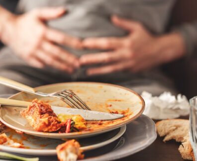 Woman,With,Bloating,And,Stomach,Pain,After,Eating