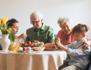 Grandparents,With,Grandchildren,Eating,Traditional,Easter,Lunch.,Recreating,Family,Traditions