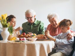 Grandparents,With,Grandchildren,Eating,Traditional,Easter,Lunch.,Recreating,Family,Traditions