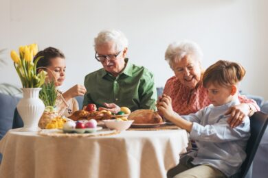 Grandparents,With,Grandchildren,Eating,Traditional,Easter,Lunch.,Recreating,Family,Traditions